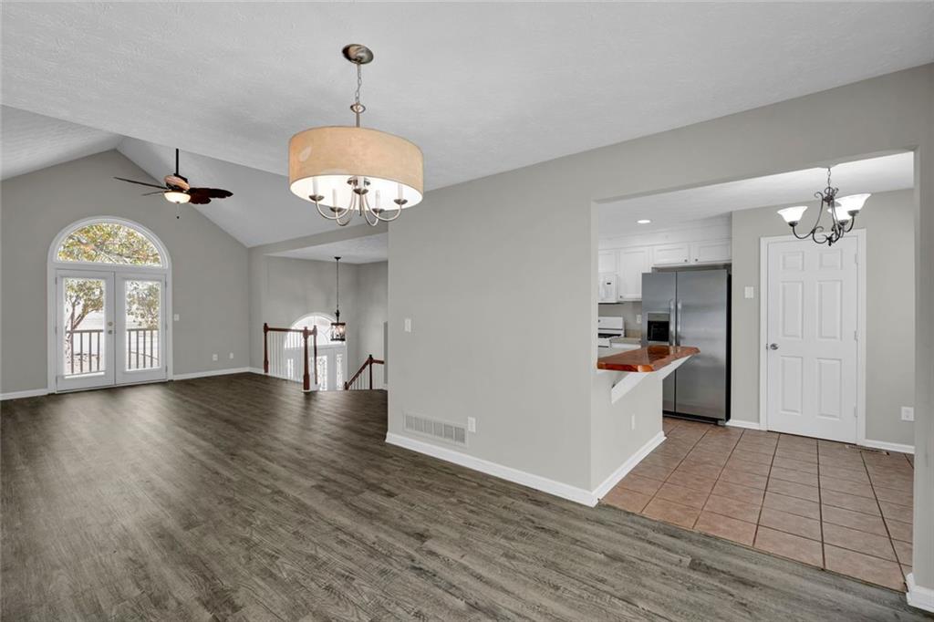 281 Cedars Glen Circle Villa Rica, GA 30180 - Photo 11 of 52 a view of a hallway with wooden floor and a kitchen