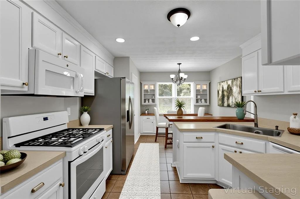 281 Cedars Glen Circle Villa Rica, GA 30180 - Photo 14 of 52 a kitchen with kitchen island a sink stove and refrigerator