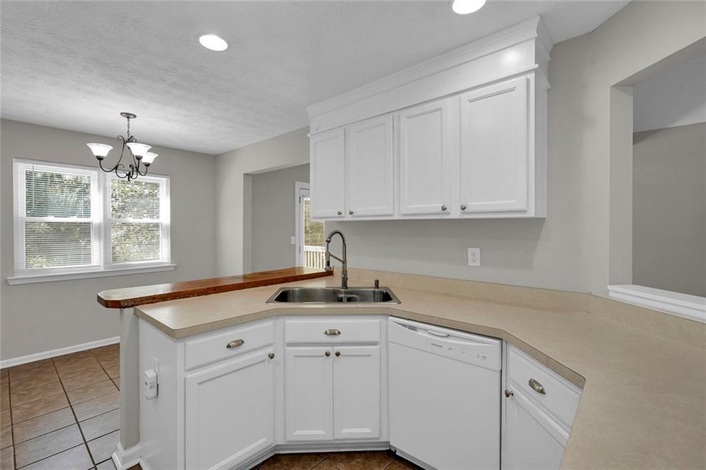 281 Cedars Glen Circle Villa Rica, GA 30180 - Photo 16 of 52 a kitchen with granite countertop white cabinets and white appliances