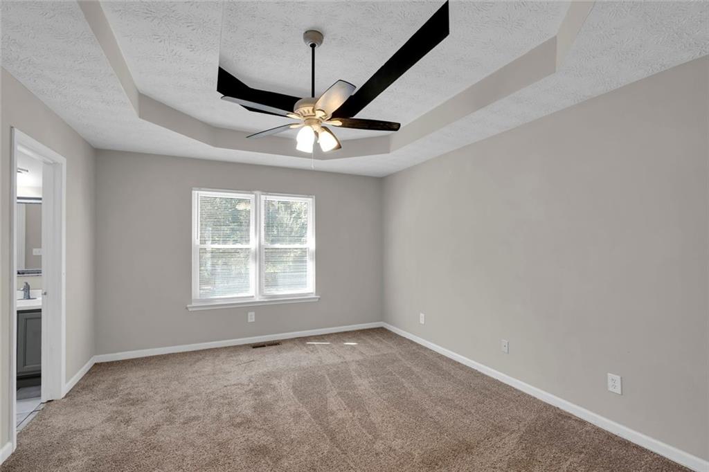 281 Cedars Glen Circle Villa Rica, GA 30180 - Photo 19 of 52 an empty room with a window and a fan