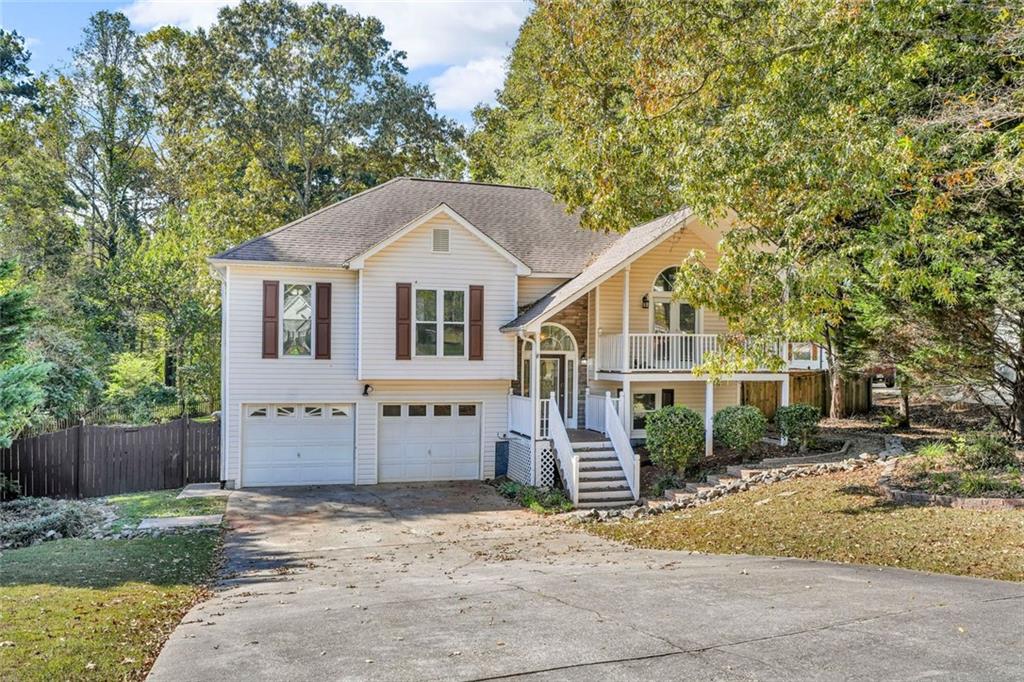 281 Cedars Glen Circle Villa Rica, GA 30180 - Photo 2 of 52 a front view of a house with a yard and garage