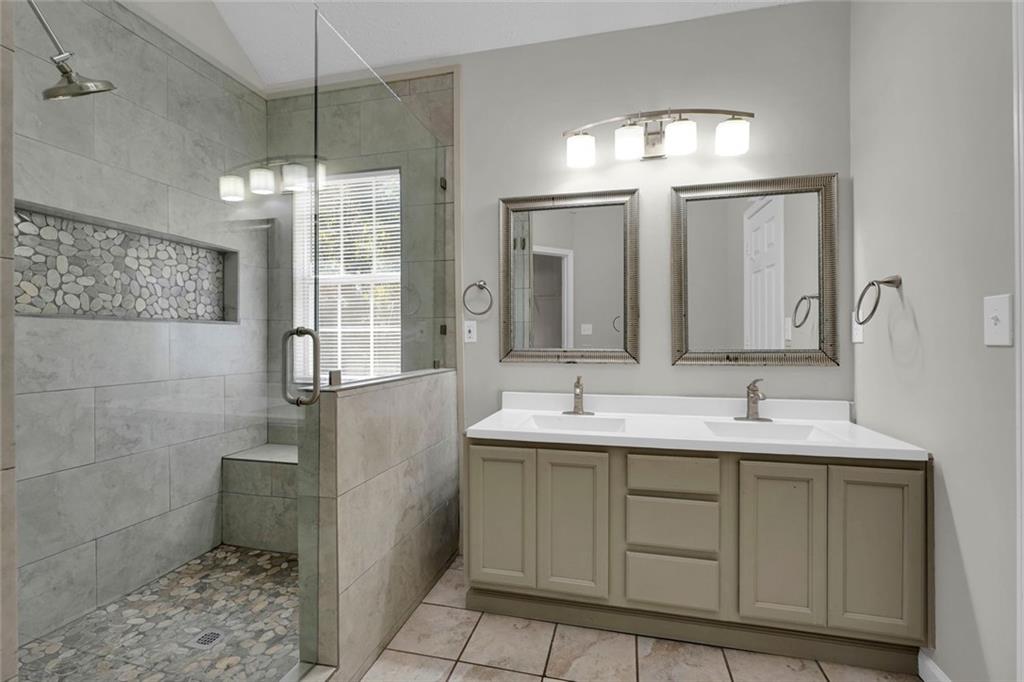 281 Cedars Glen Circle Villa Rica, GA 30180 - Photo 24 of 52 a bathroom with a double vanity sink toilet and a mirror
