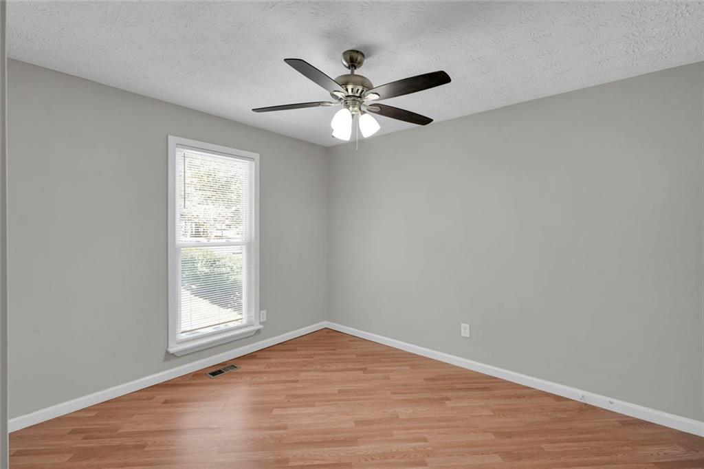 281 Cedars Glen Circle Villa Rica, GA 30180 - Photo 28 of 52 wooden floor in an empty room with a window