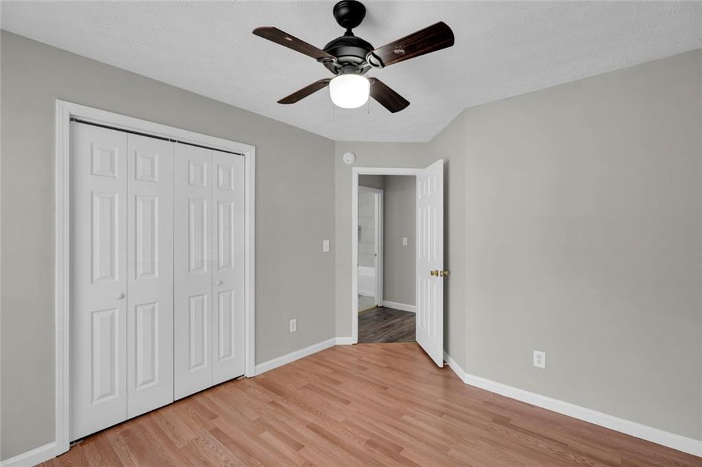 281 Cedars Glen Circle Villa Rica, GA 30180 - Photo 32 of 52 wooden floor in an empty room with a chandelier fan