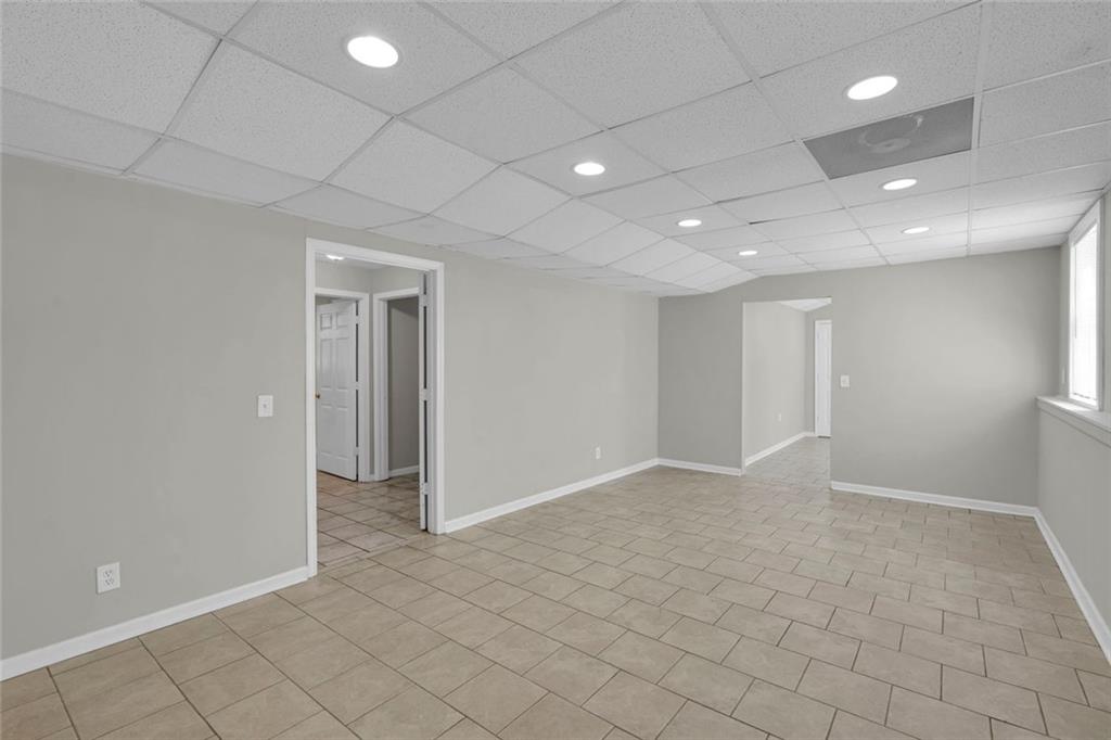 281 Cedars Glen Circle Villa Rica, GA 30180 - Photo 39 of 52 an empty room with white walls and tiles