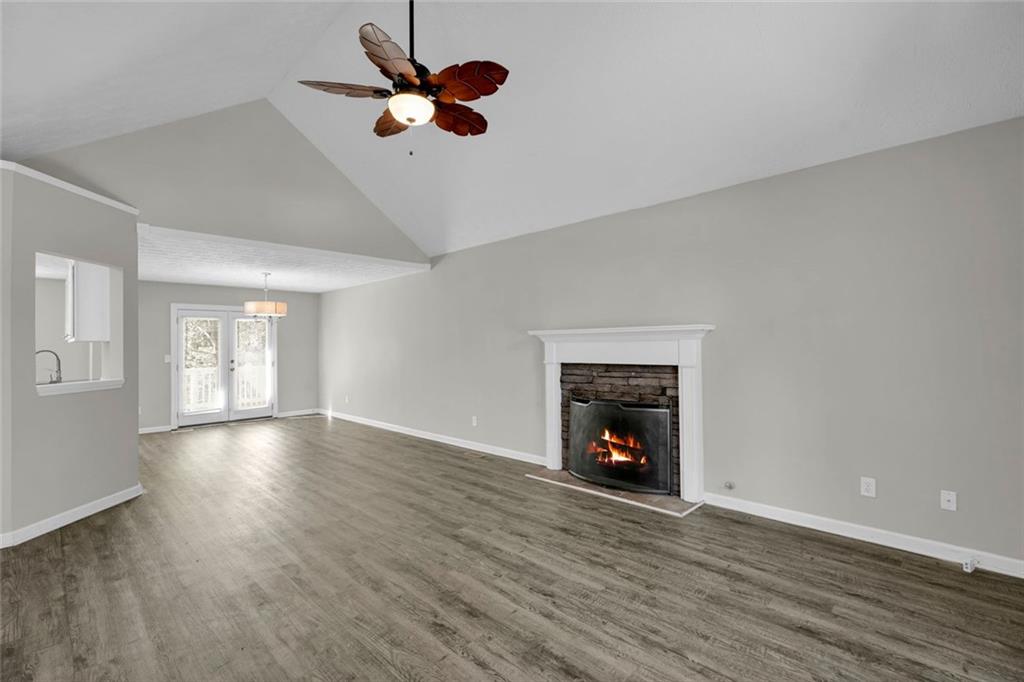 281 Cedars Glen Circle Villa Rica, GA 30180 - Photo 7 of 52 wooden floor in an empty room with a fireplace