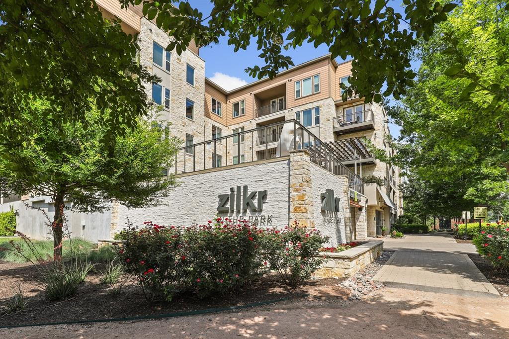 1900 Barton Springs Road, Unit 3013 Austin, TX 78704 - Photo 27 of 27 A grand entrance welcomes residents to this contemporary building, nestled among mature trees and vibrant landscaping.