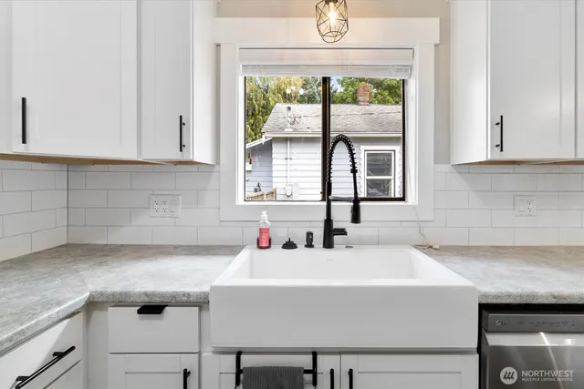 a kitchen with a sink and large window