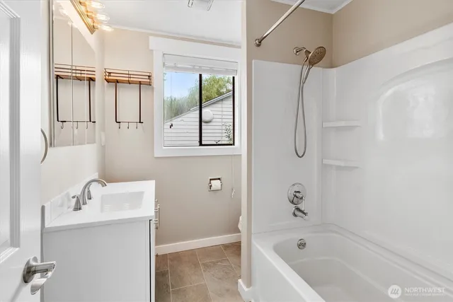 a bathroom with a tub a sink and mirror