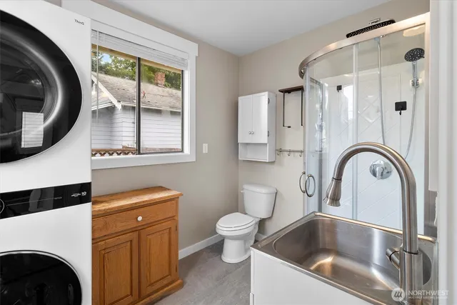 a bathroom with a sink a toilet and a mirror