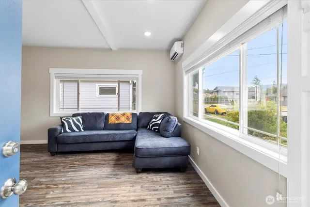 a living room with furniture and a large window