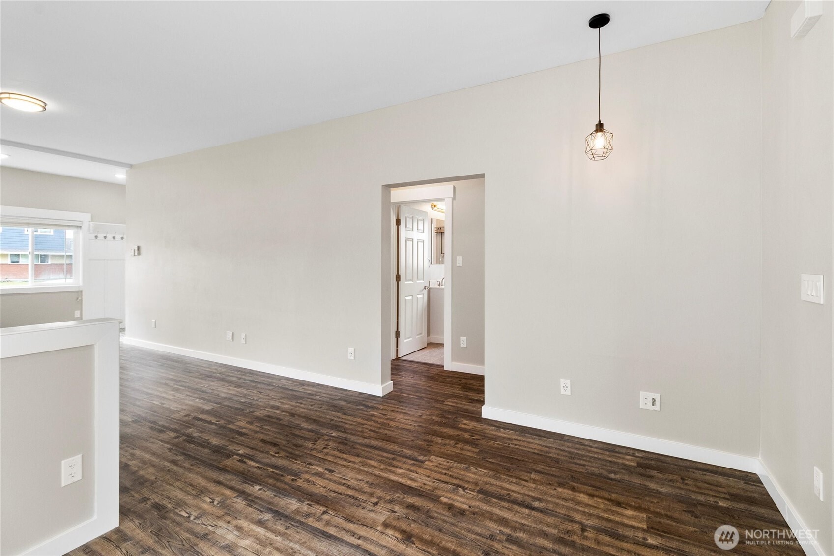 310 Second Street Sumas, WA 98295 - Photo 9 of 28 a view of an empty room with wooden floor and a window
