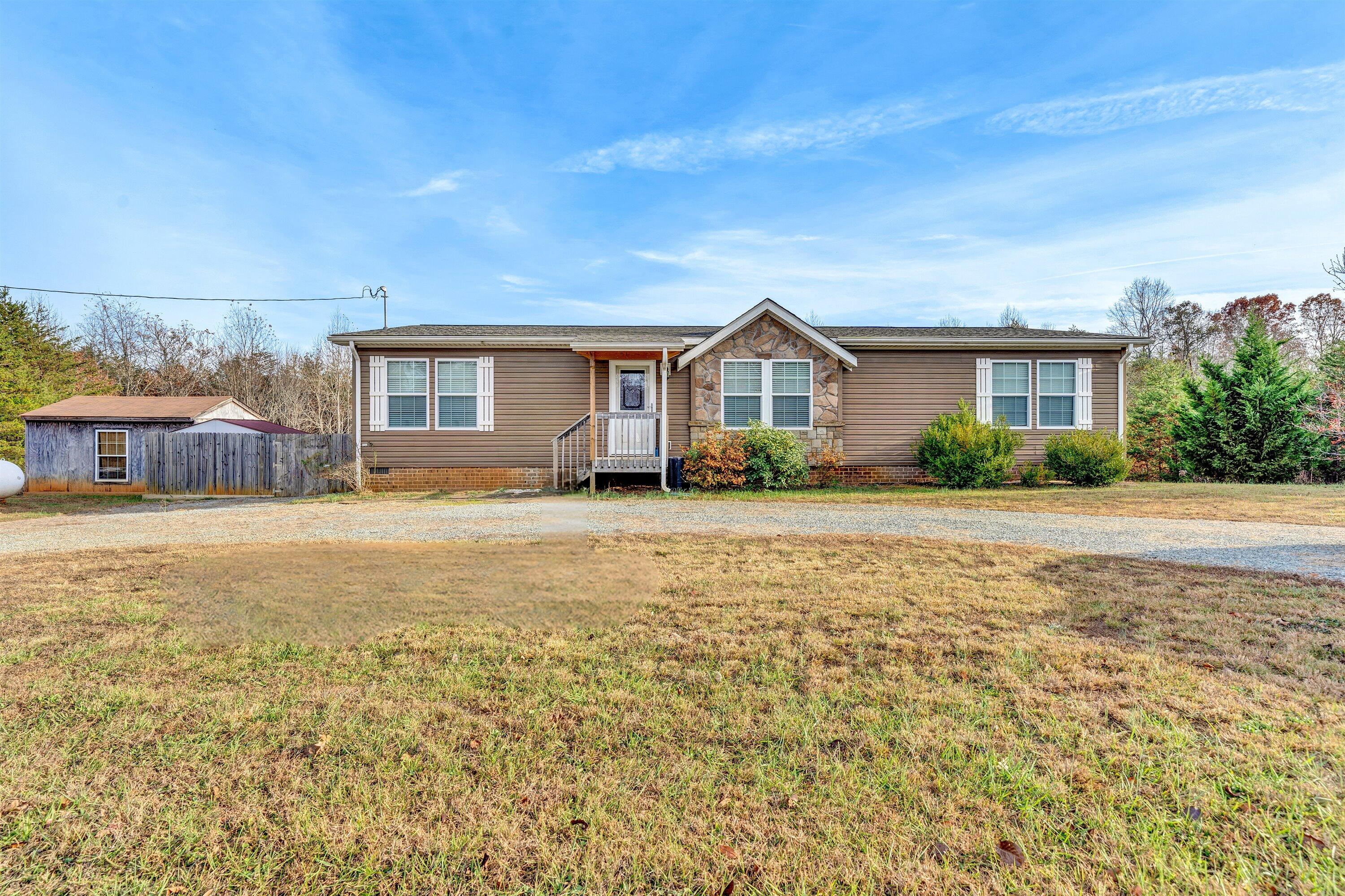 590 Belcher Road Penhook, VA 24137 - Photo 1 of 23 a front view of a house with a garden