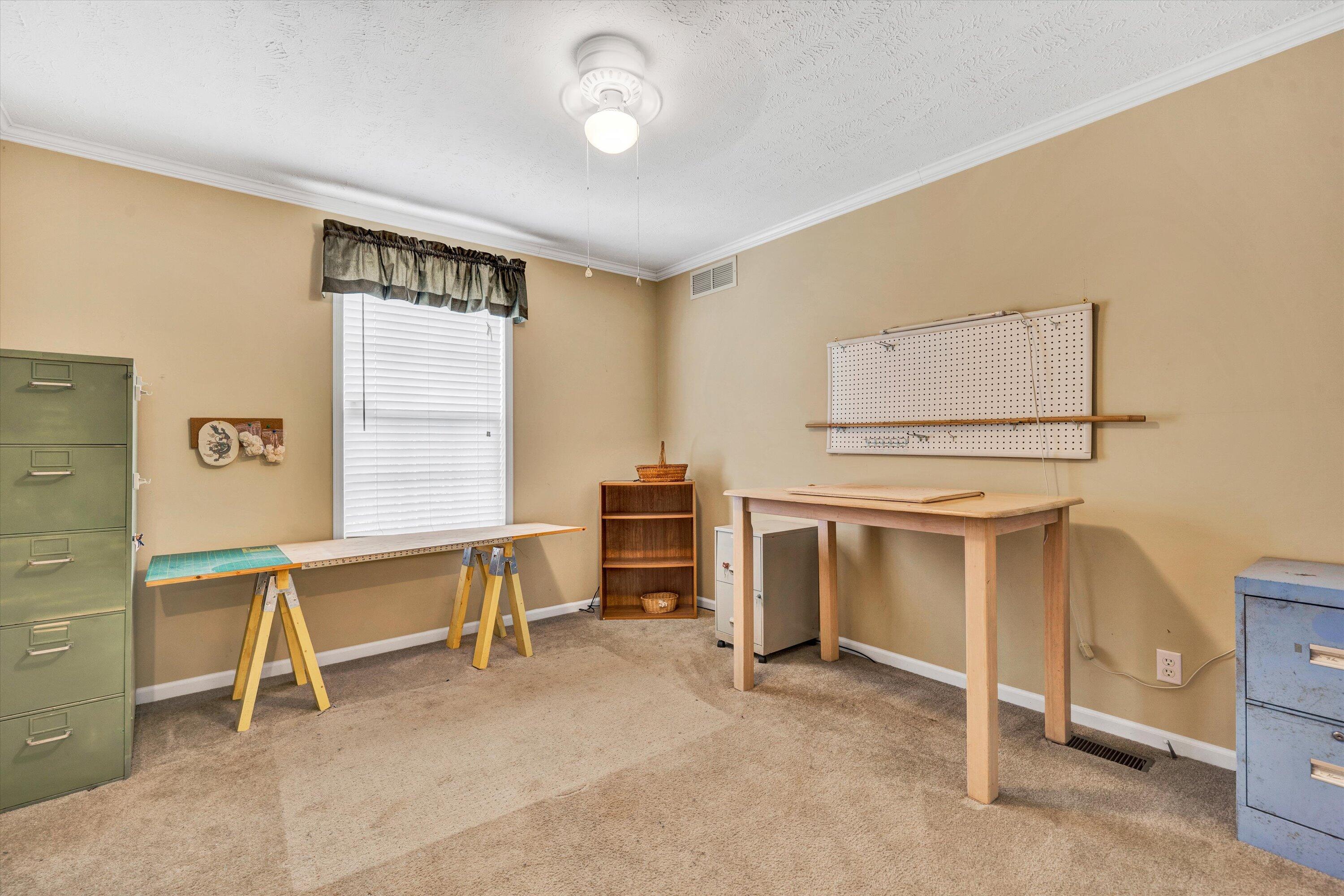 590 Belcher Road Penhook, VA 24137 - Photo 14 of 23 a view of a workspace with furniture and a window