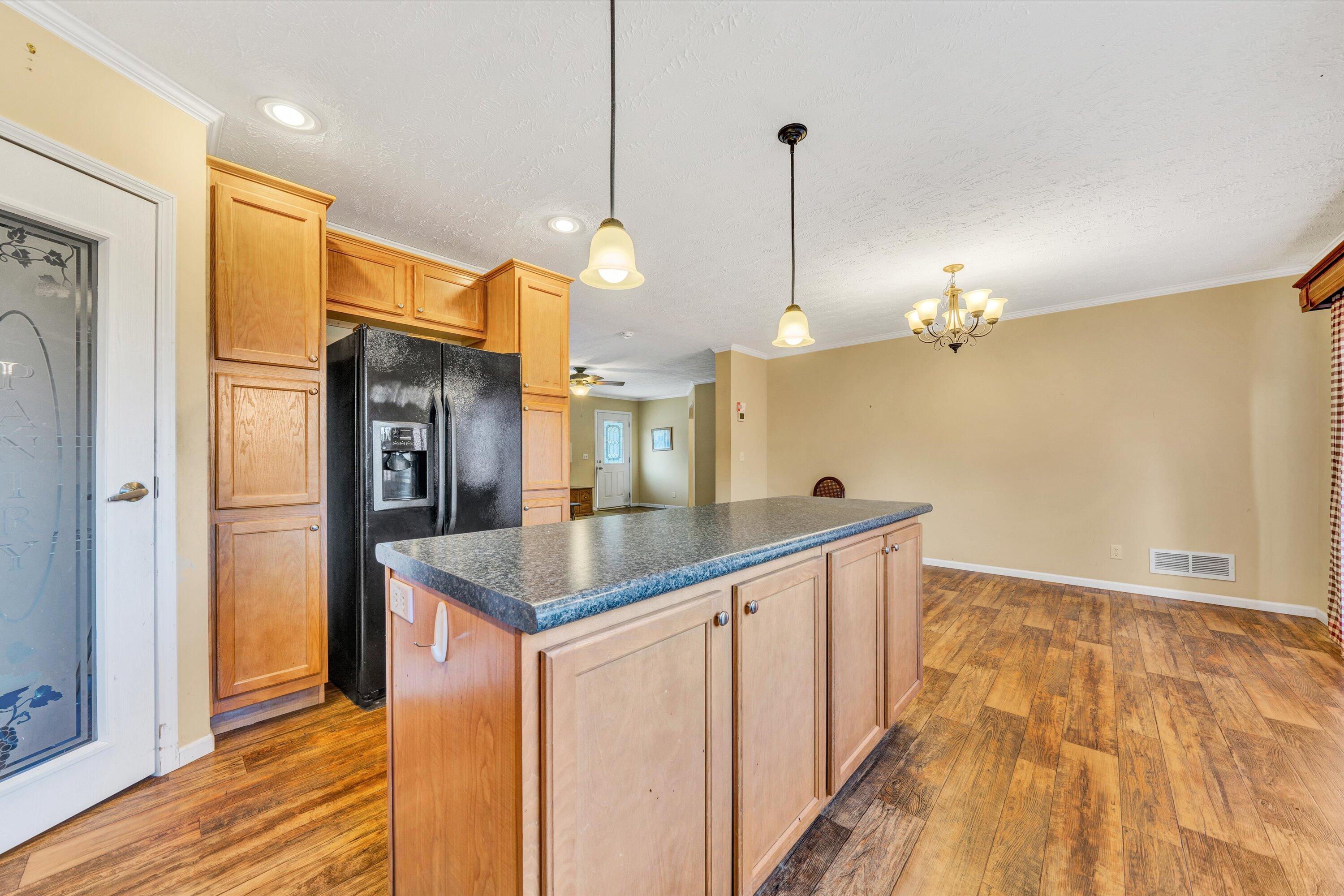 590 Belcher Road Penhook, VA 24137 - Photo 8 of 23 a kitchen with stainless steel appliances granite countertop a sink a refrigerator and a wooden floor