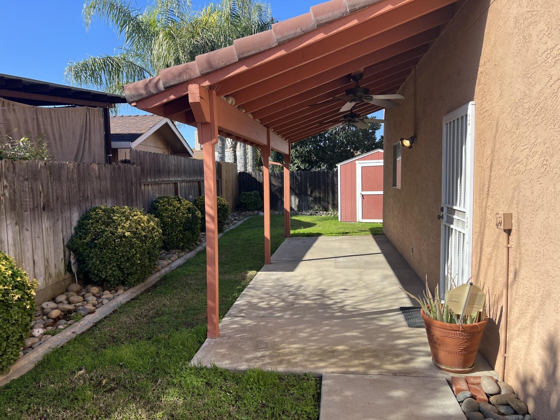 3816 Teek Court Ceres, CA 95307 - Photo 14 of 21 Fenced backyard featuring a shed and ceiling fan