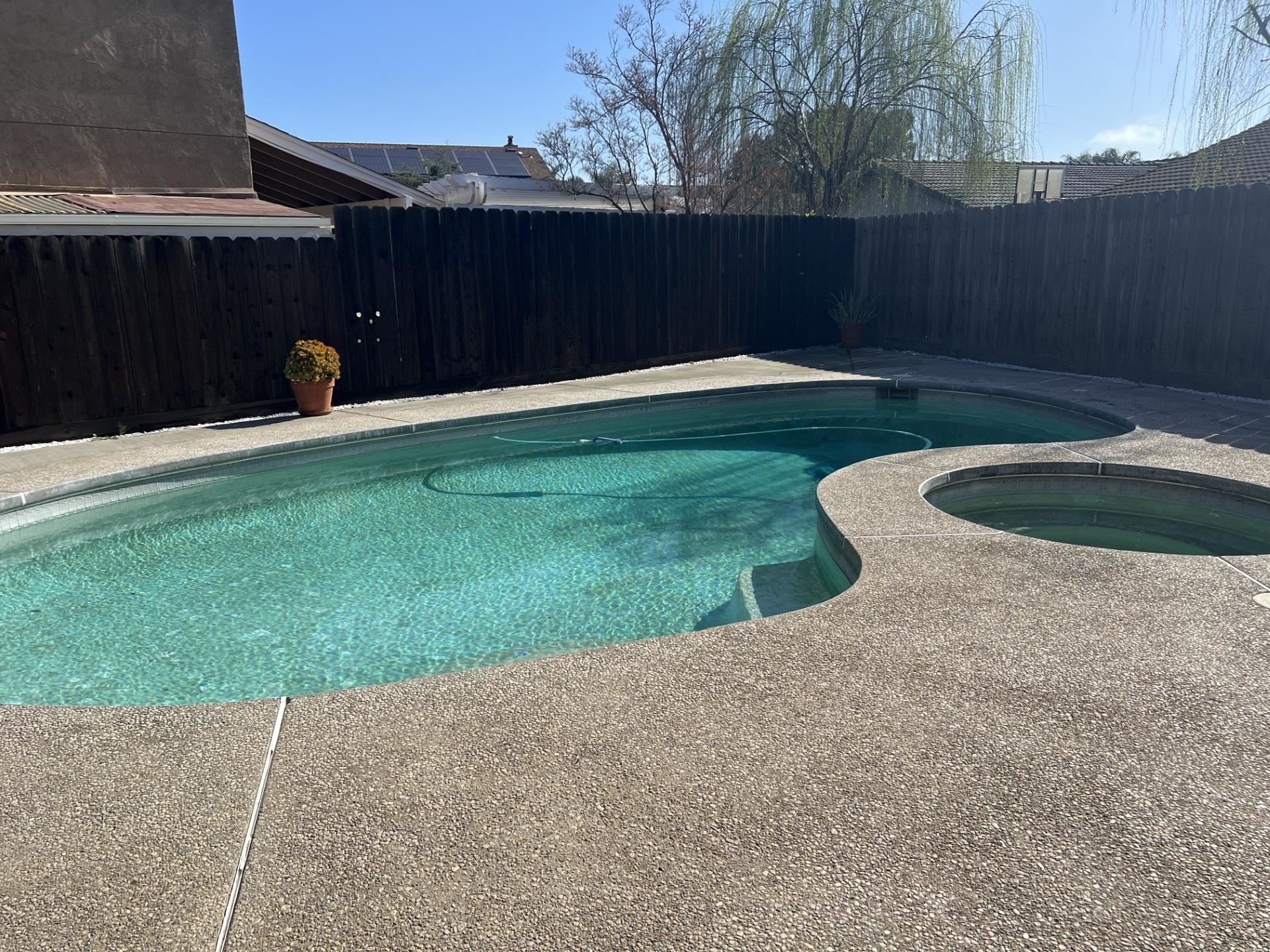 3816 Teek Court Ceres, CA 95307 - Photo 19 of 21 View of pool featuring a fenced backyard, an in-ground hot tub, and patio surround