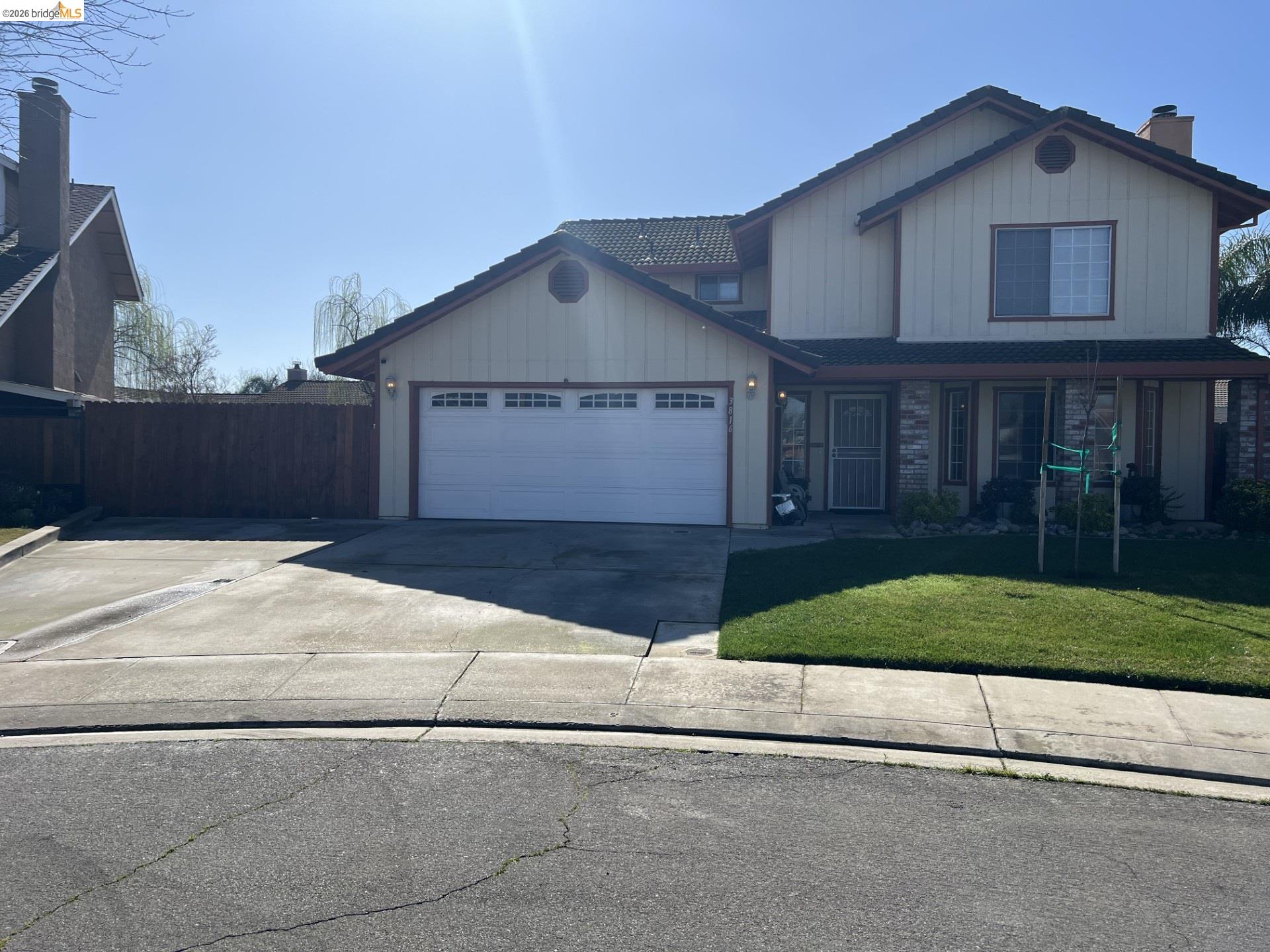 3816 Teek Court Ceres, CA 95307 - Photo 2 of 21 a front view of a house with a yard and garage