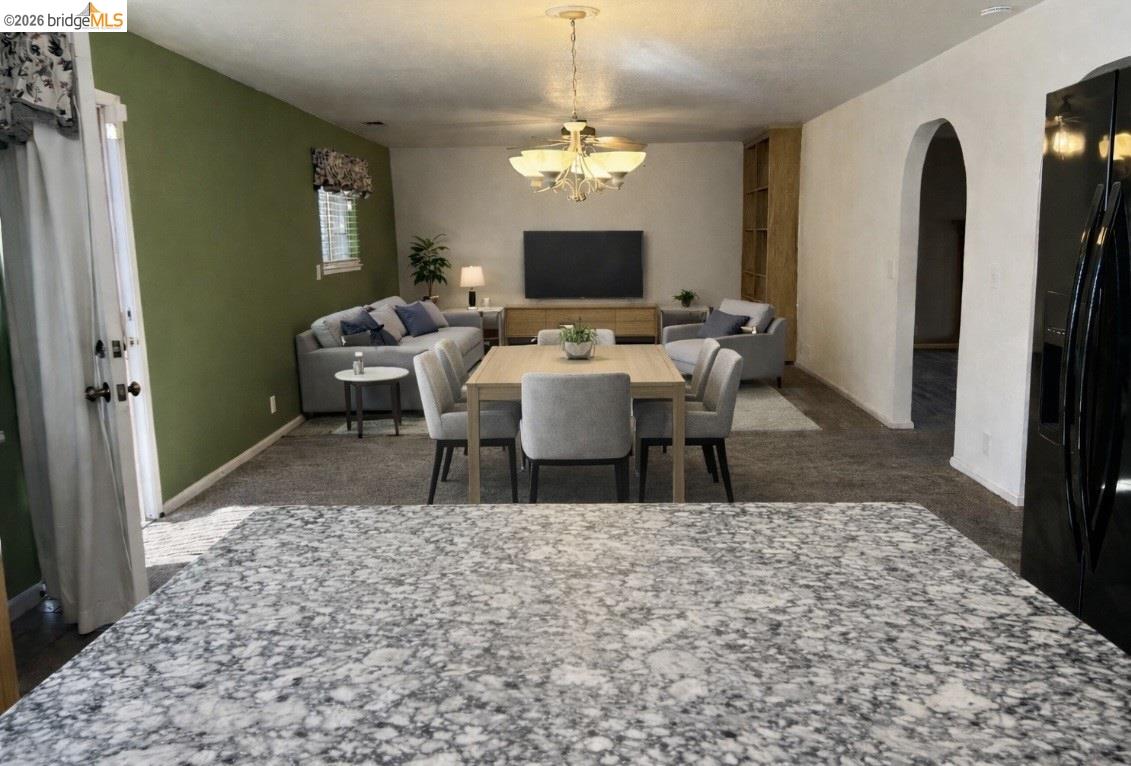 3816 Teek Court Ceres, CA 95307 - Photo 5 of 21 a living room with furniture a rug a flat screen tv and a table