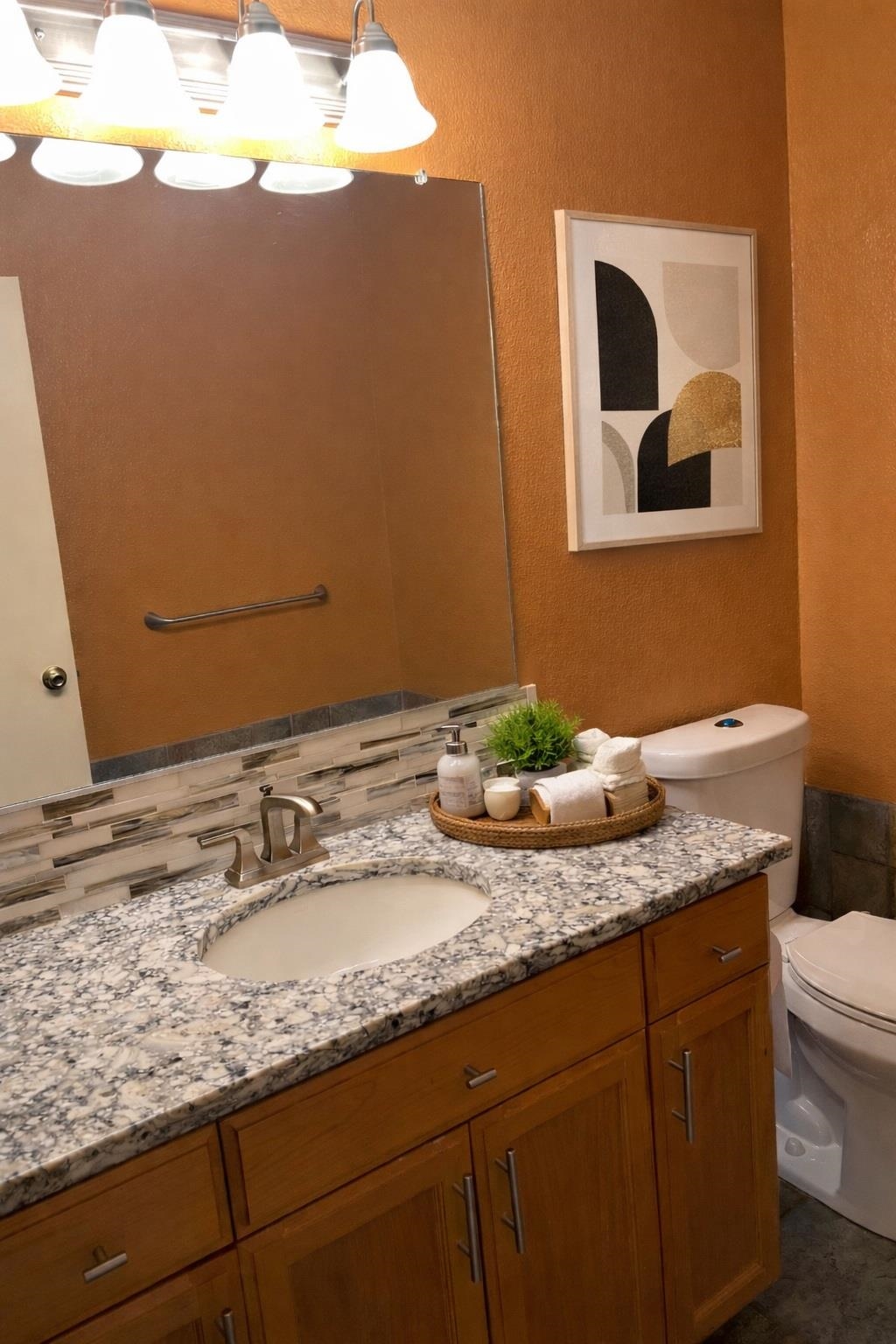 3816 Teek Court Ceres, CA 95307 - Photo 7 of 21 Bathroom featuring a textured wall, vanity, and decorative backsplash
