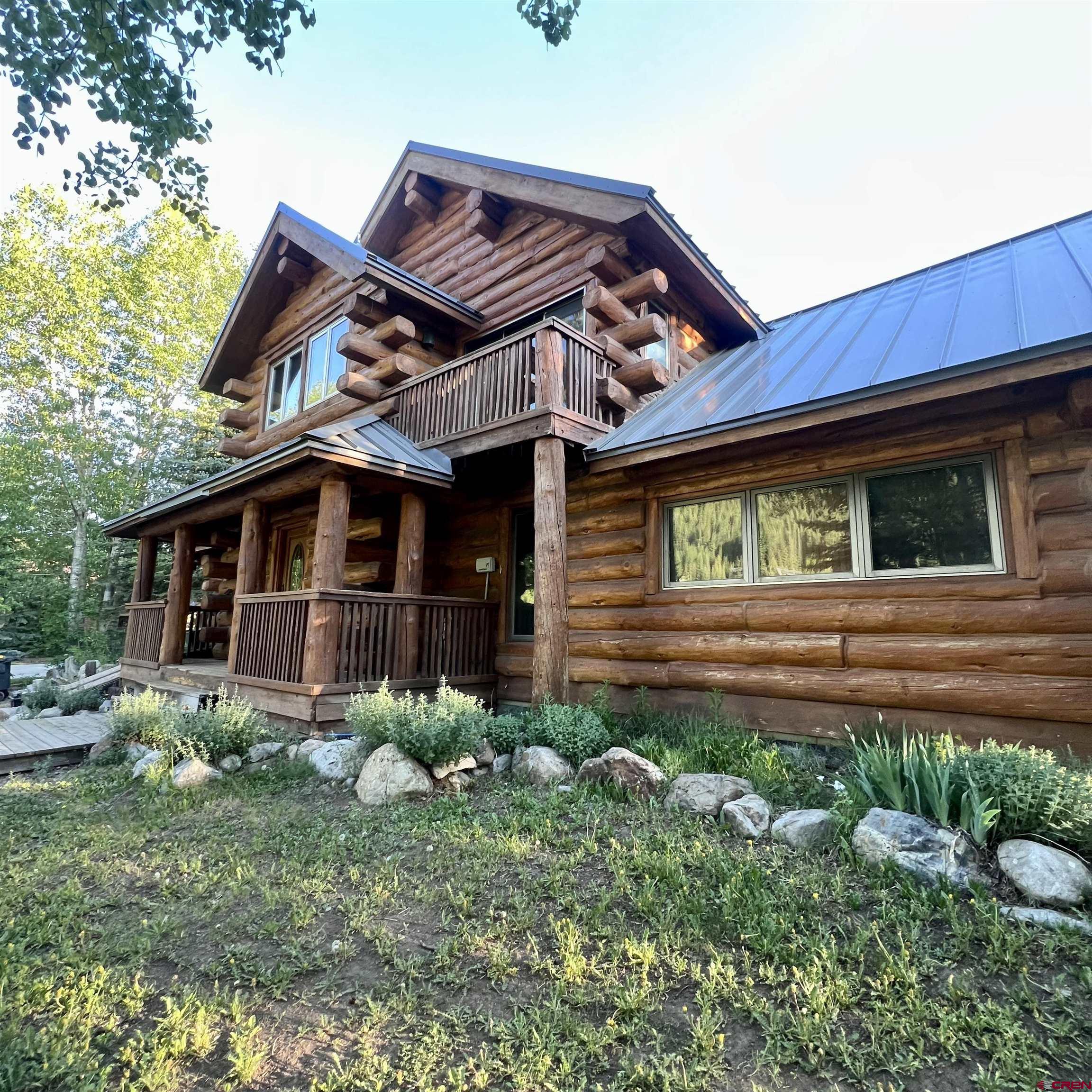398 Journey's End Road Crested Butte, CO 81224 - Photo 15 of 42 a view of a house with a small yard and plants