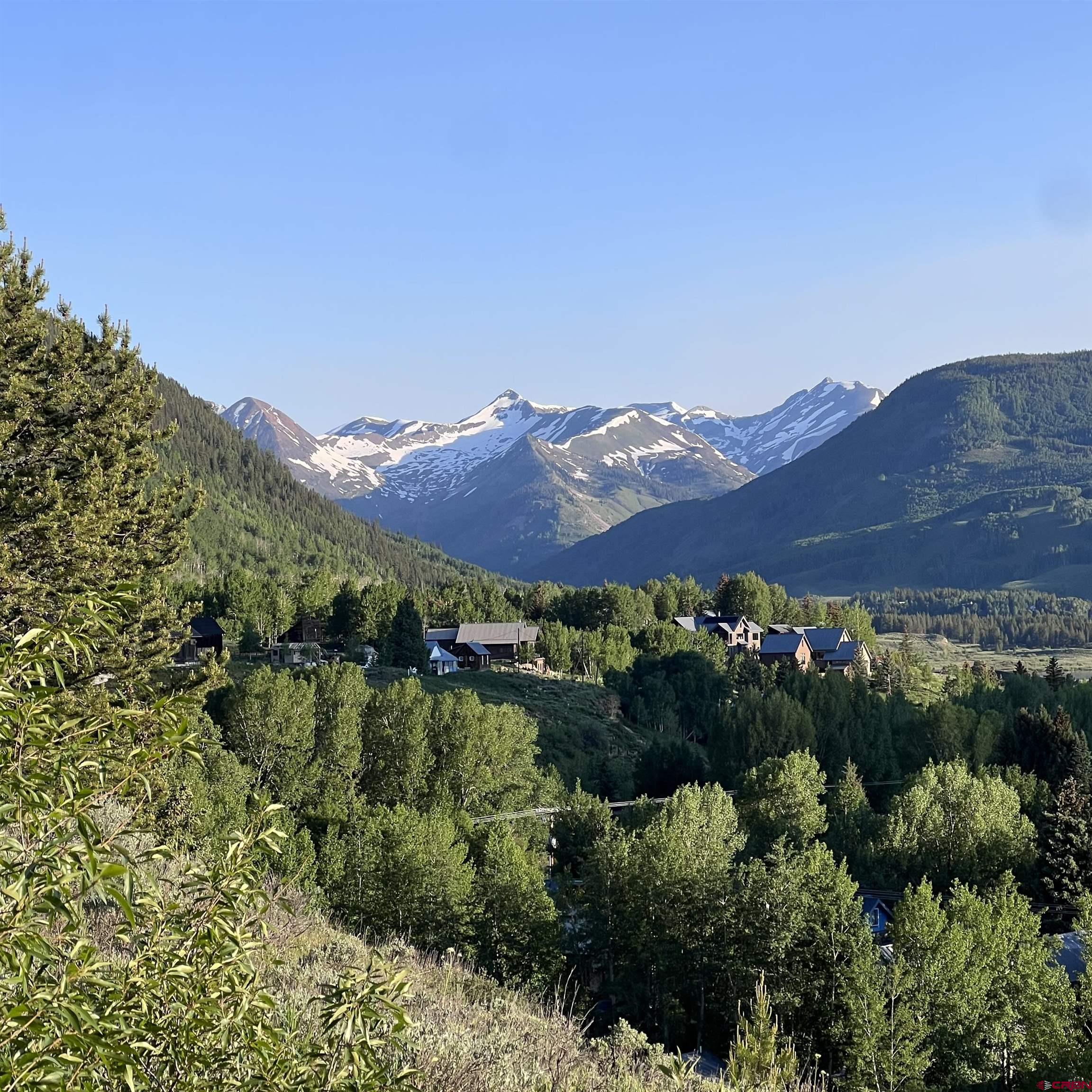 398 Journey's End Road Crested Butte, CO 81224 - Photo 4 of 42 a view of a lush green field with mountains in the background