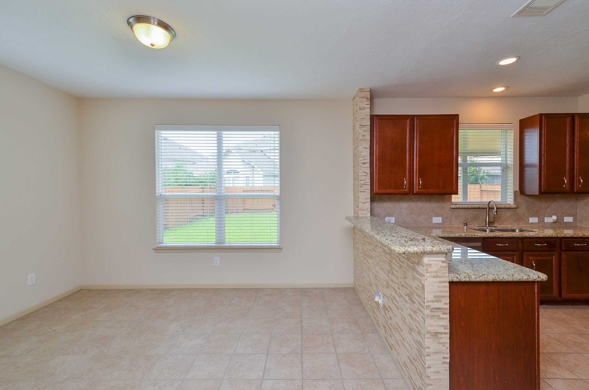 25135 Ginger Ranch Drive Katy, TX 77494 - Photo 11 of 32 A functional layout offers generous counter space, tile flooring, and seamless flow to the adjacent dining area.