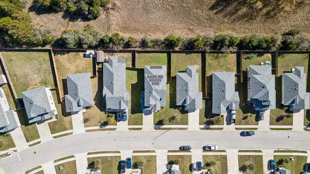 aerial view of a house with a yard