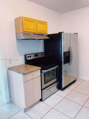 a kitchen with a stove and a microwave