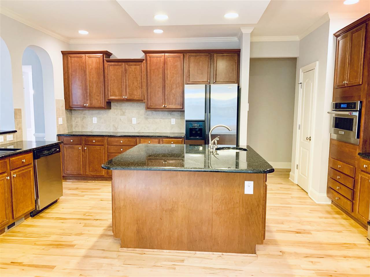 8917 Riverview Park Drive Raleigh, NC 27613 - Photo 9 of 29 With granite counter tops, SS appliances, gas range, huge island w/prep sink and plenty of cabinets and counter space...perfect for the family chef! Kitchen