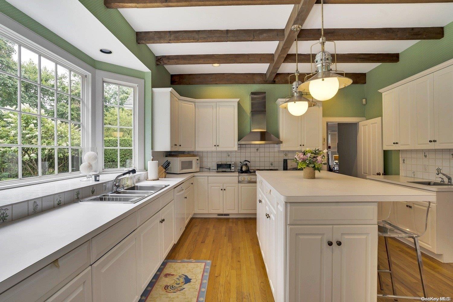 5 Shinnecock Road Quogue, NY 11959 - Photo 13 of 35 a kitchen with a sink a counter top space appliances and a window