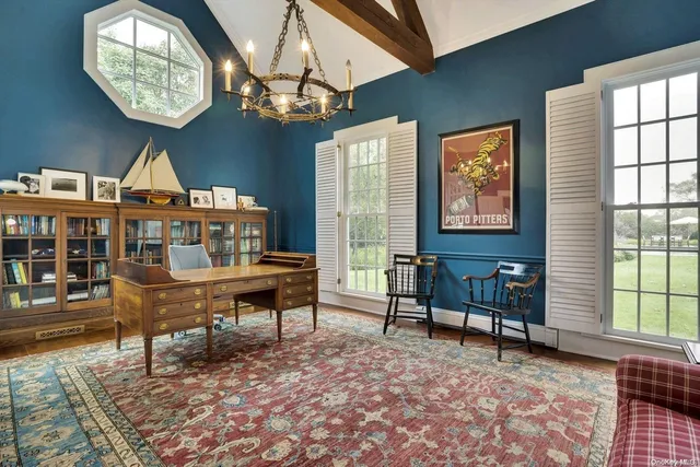 a living room with furniture a chandelier and a window