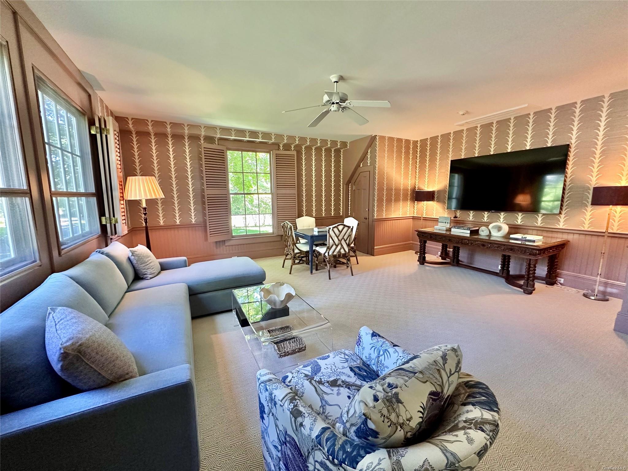5 Shinnecock Road Quogue, NY 11959 - Photo 18 of 35 a living room with furniture and a flat screen tv
