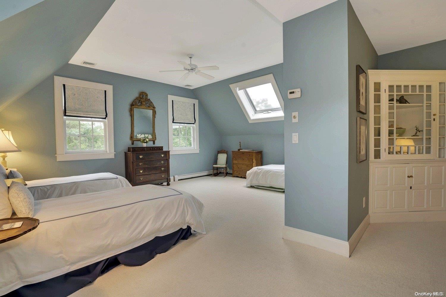 5 Shinnecock Road Quogue, NY 11959 - Photo 22 of 35 a bedroom with a bed and a dresser next to a window