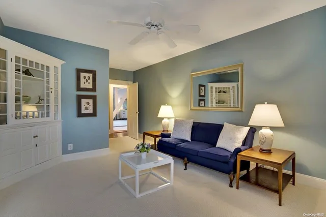 a living room with furniture a lamp and a window