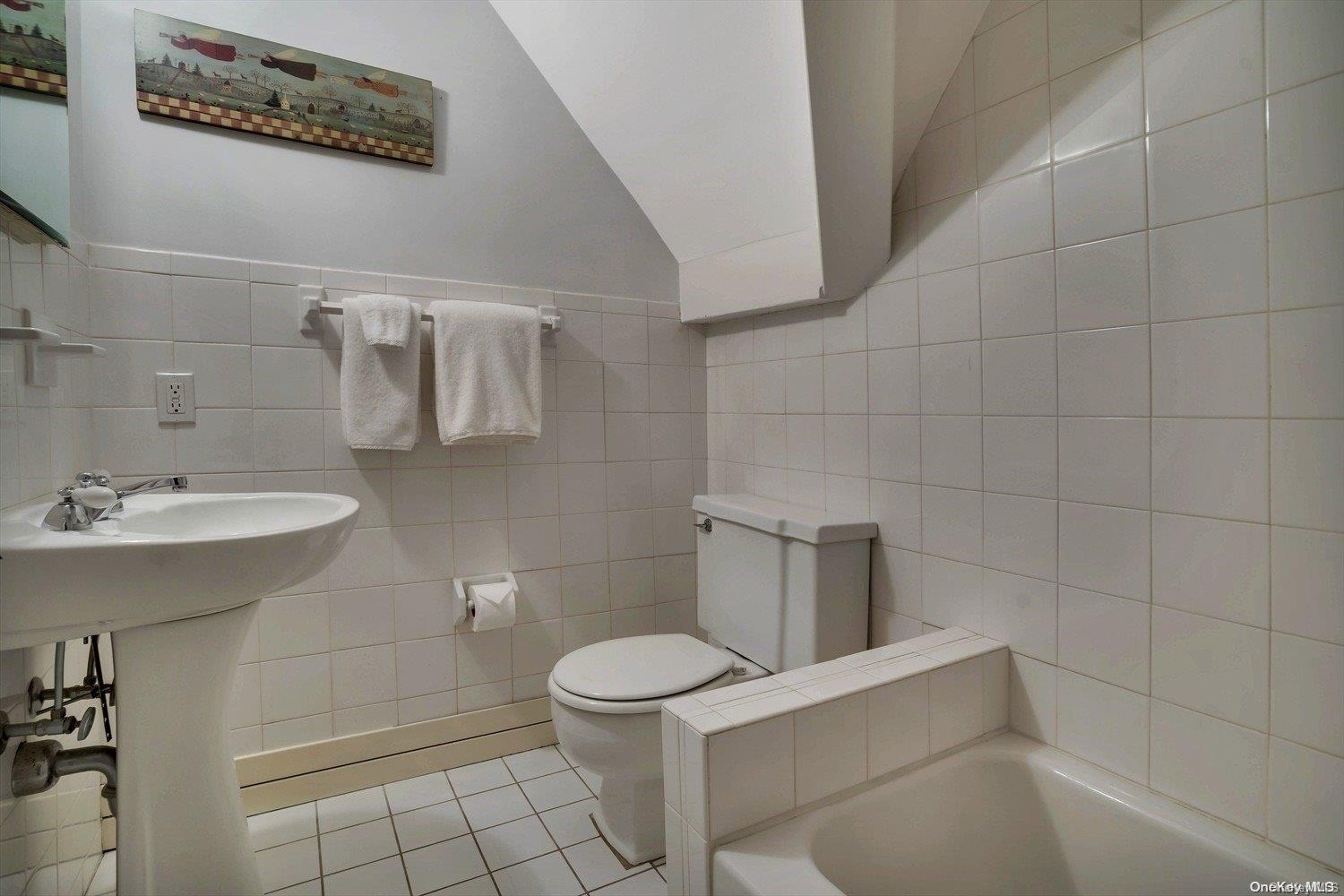 5 Shinnecock Road Quogue, NY 11959 - Photo 25 of 35 a bathroom with a sink a toilet and a mirror