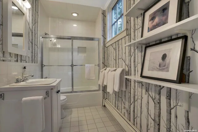 a bathroom with a sink mirror and toilet