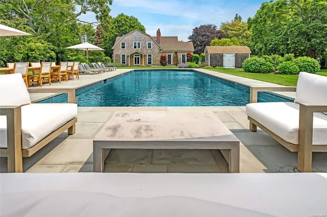 a aerial view of a house with swimming pool and sitting area