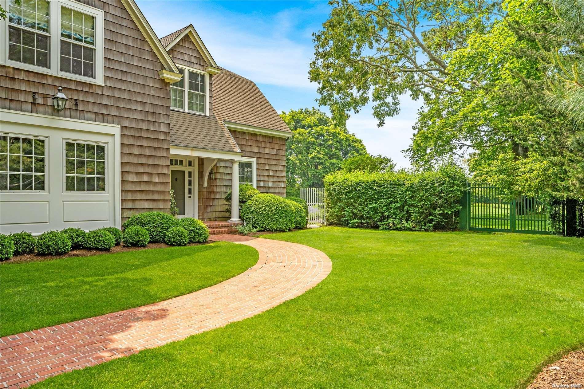 5 Shinnecock Road Quogue, NY 11959 - Photo 3 of 35 a front view of a house with a yard
