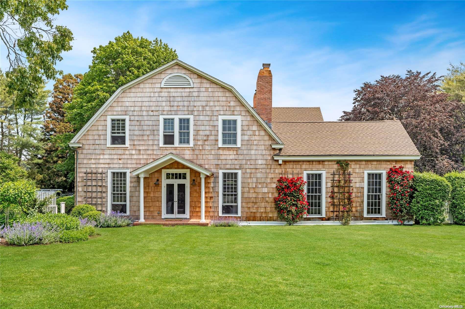 5 Shinnecock Road Quogue, NY 11959 - Photo 34 of 35 a front view of a house with a garden