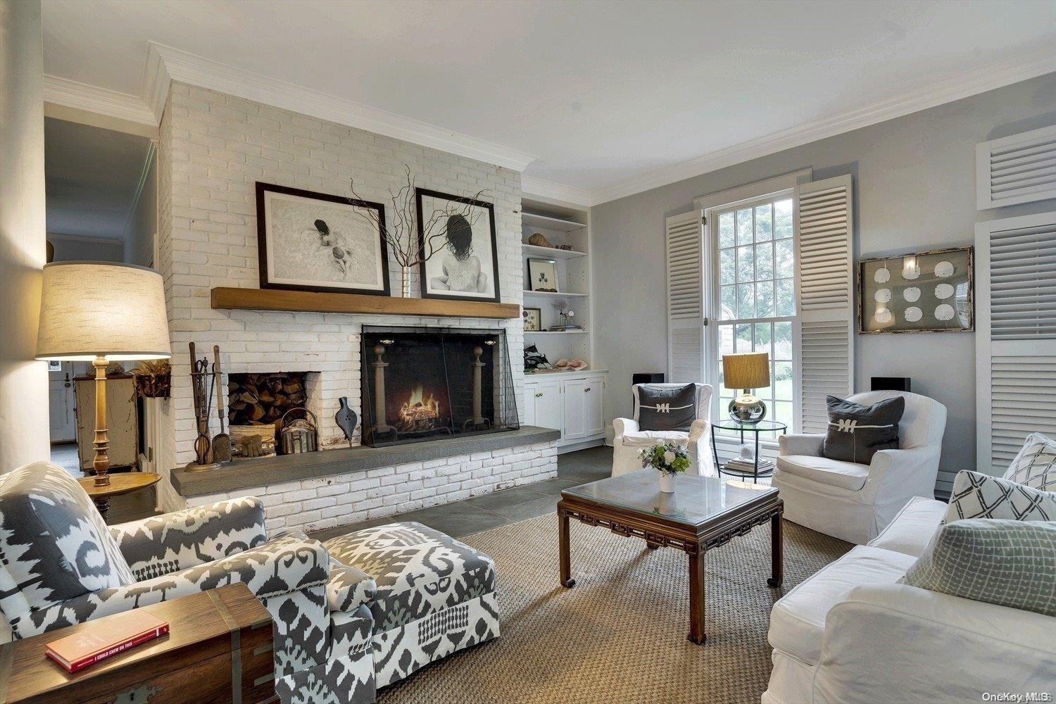 5 Shinnecock Road Quogue, NY 11959 - Photo 6 of 35 a living room with furniture and a fireplace