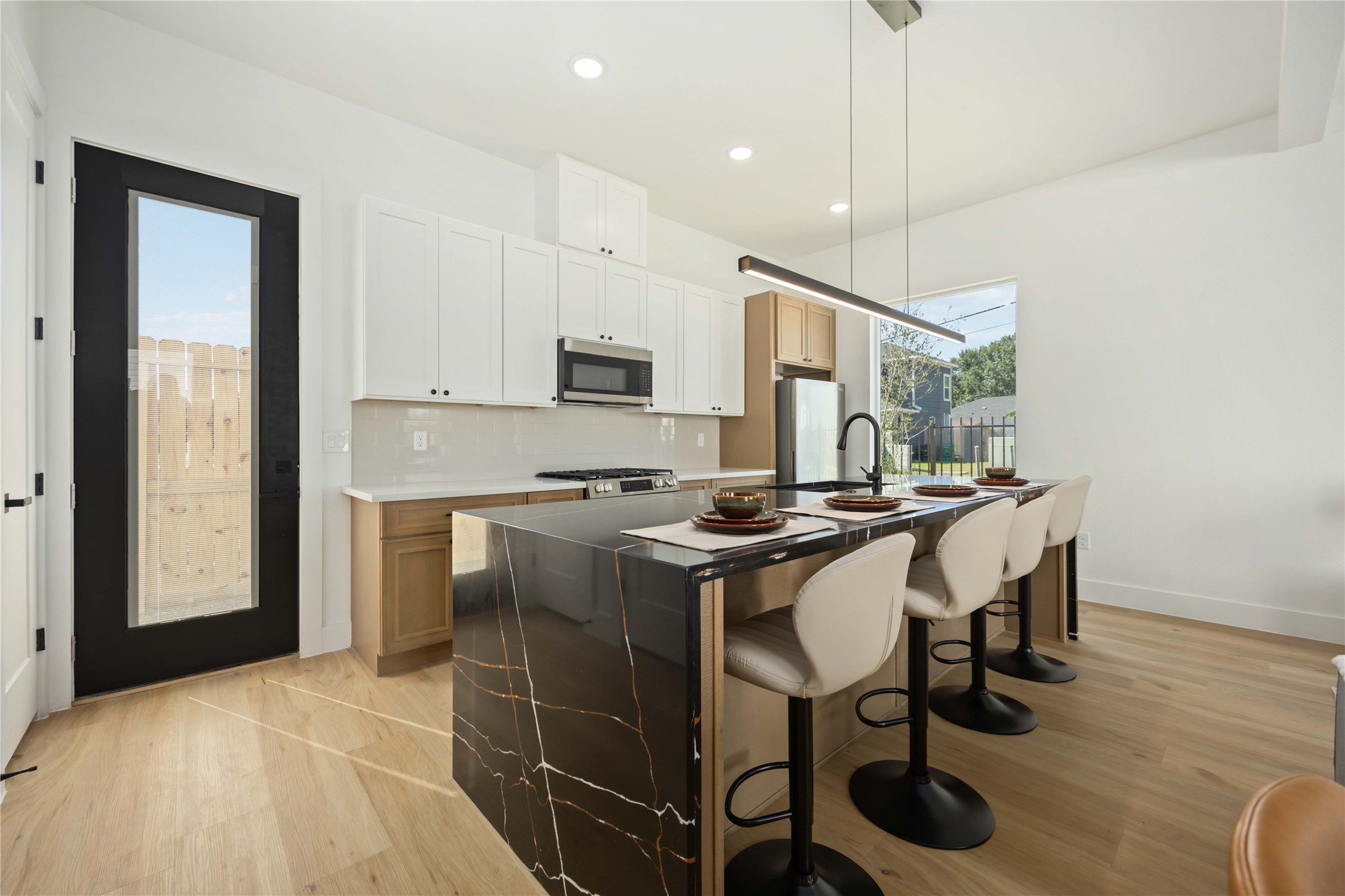 4202 Kewanee Street, Unit B Houston, TX 77051 - Photo 12 of 47 a kitchen with stainless steel appliances a table chairs and a refrigerator