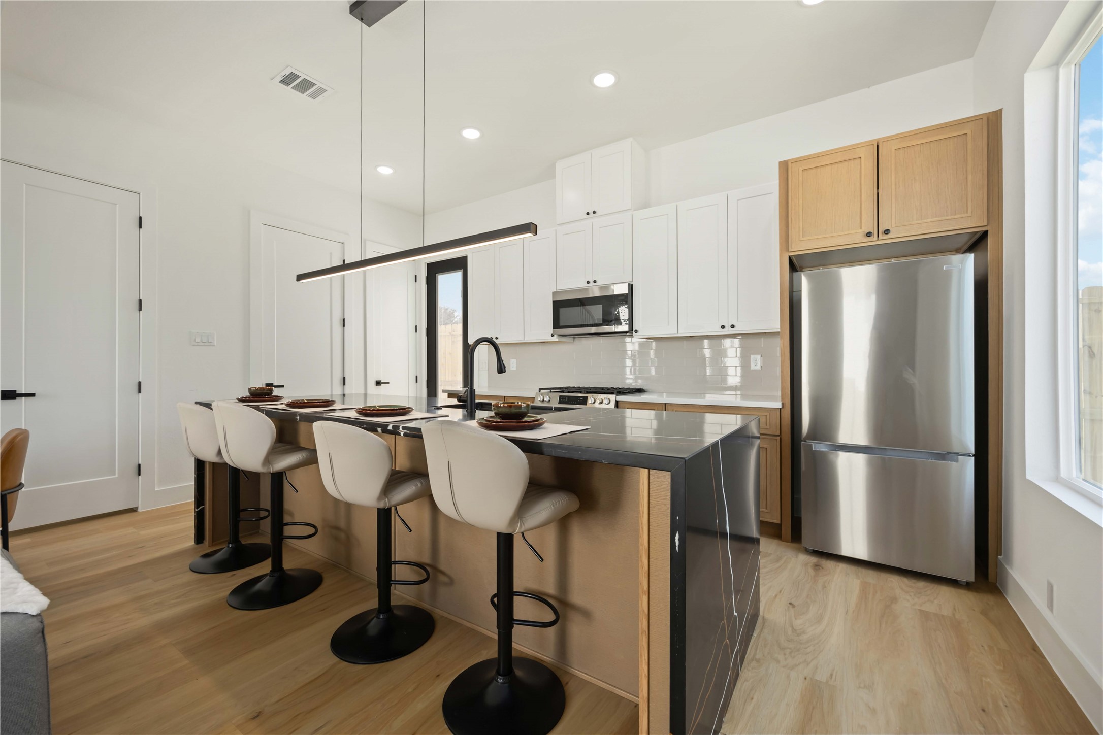 4202 Kewanee Street, Unit B Houston, TX 77051 - Photo 13 of 47 a kitchen with refrigerator and chairs