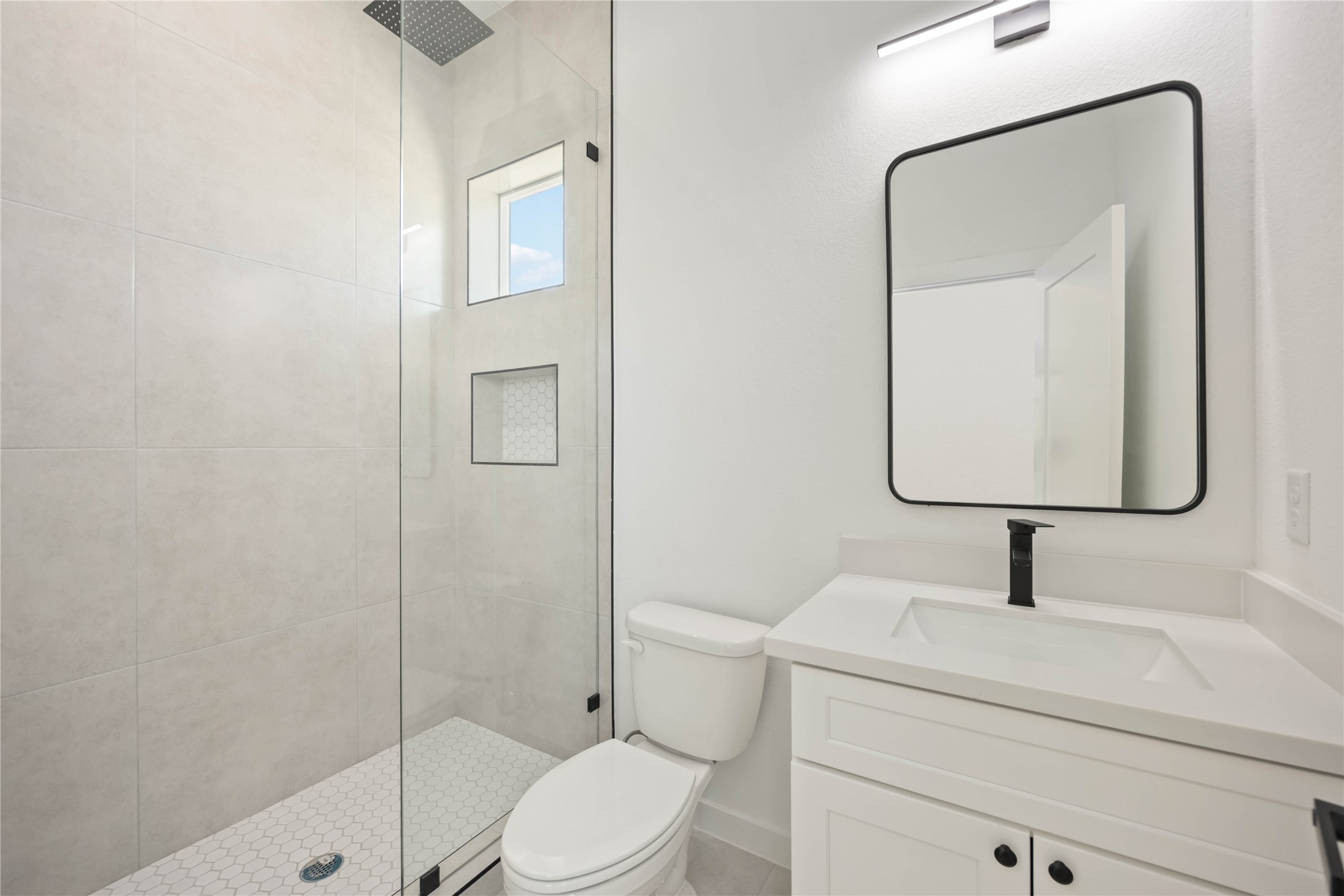 4202 Kewanee Street, Unit B Houston, TX 77051 - Photo 30 of 47 a bathroom with a toilet sink vanity and shower