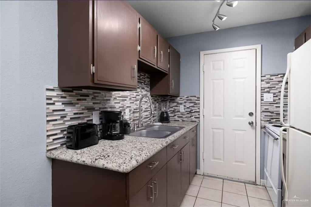 2428 Upas Avenue, Unit 5 McAllen, TX 78501 - Photo 6 of 9 a kitchen with a sink a counter space and cabinets
