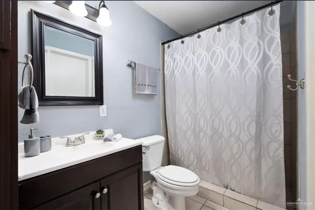 a bathroom with a sink vanity mirror and toilet
