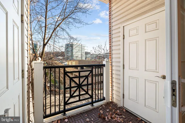 a view of a balcony with wooden fence and floor