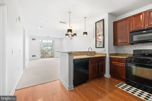 a kitchen with stainless steel appliances granite countertop a stove and a refrigerator