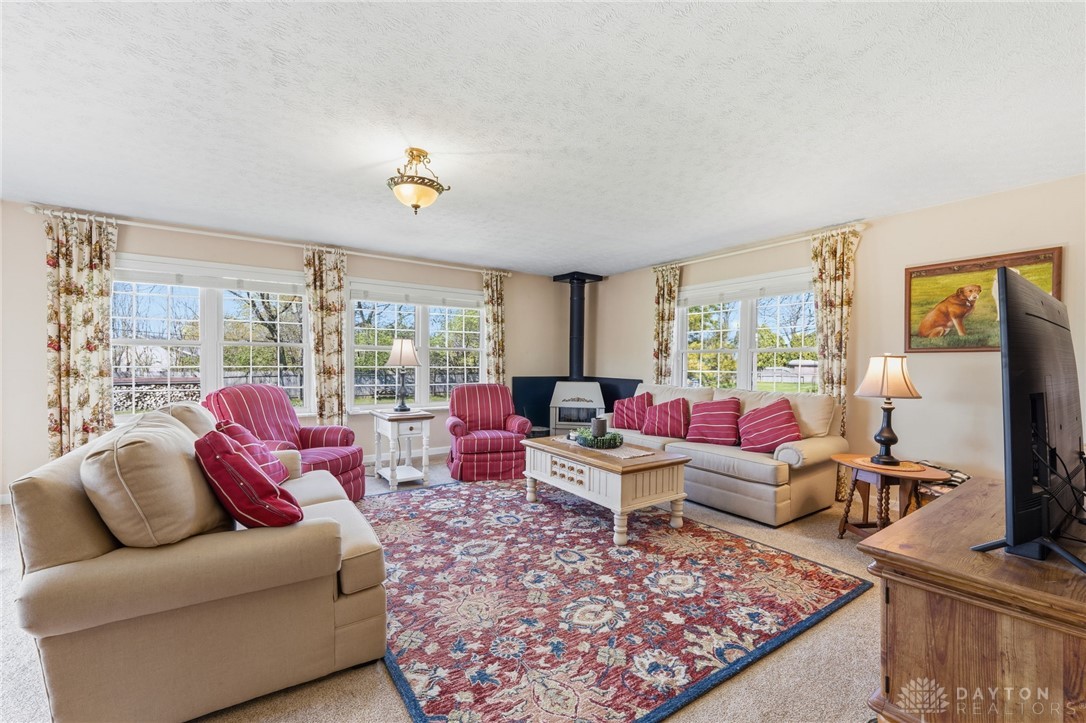 2945 Ashlar Drive Springfield, OH 45503 - Photo 9 of 20 This inviting living room features ample natural light and a comforting wood burning stove