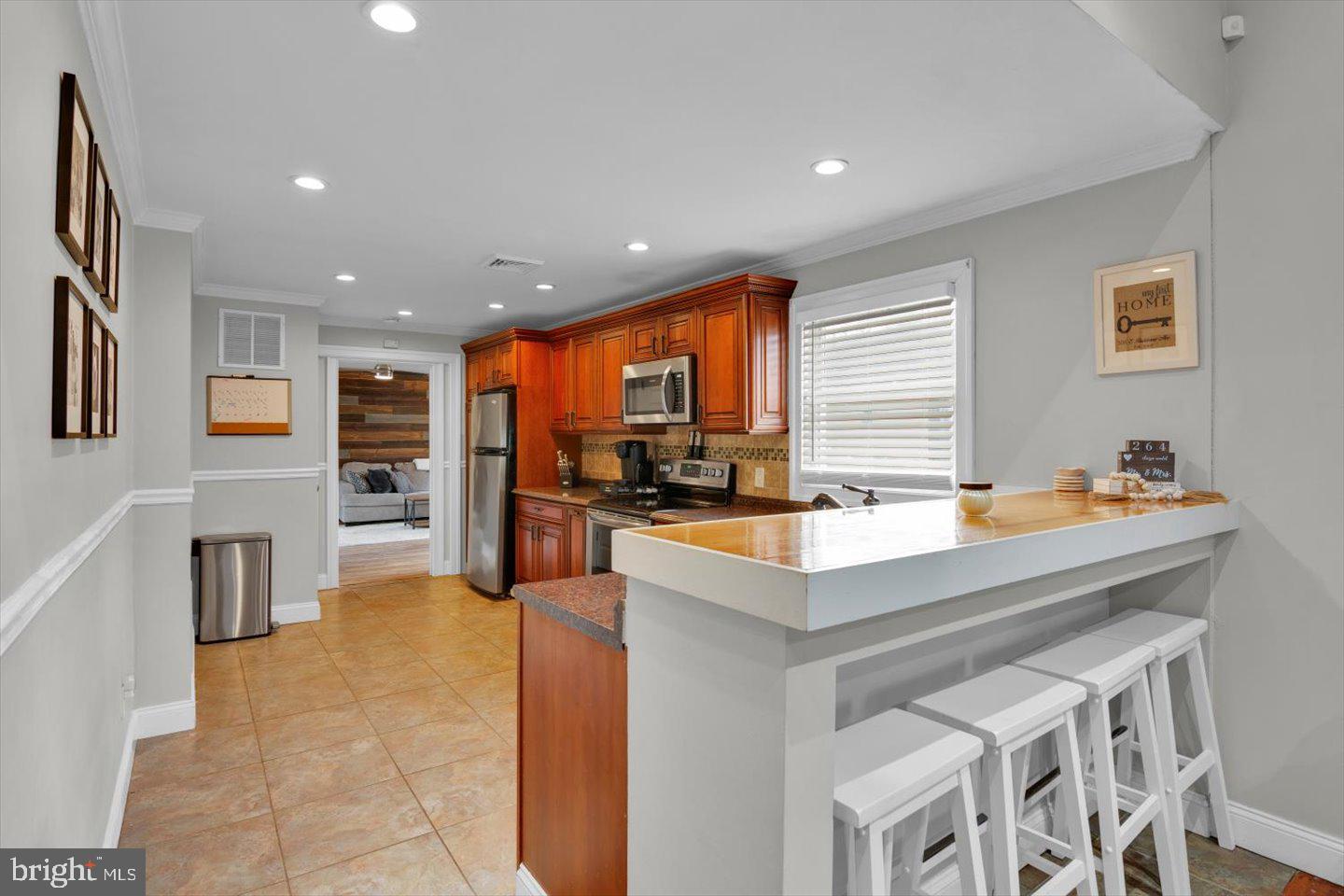 306 East Rudderow Avenue Maple Shade, NJ 08052 - Photo 11 of 38 a kitchen with stainless steel appliances granite countertop a sink stove and refrigerator